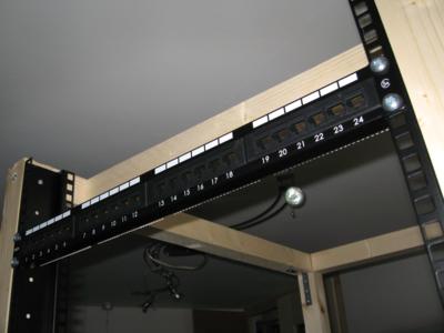 The first piece of equipment to be mounted - a 24 port RJ45/CAT5 patch panel